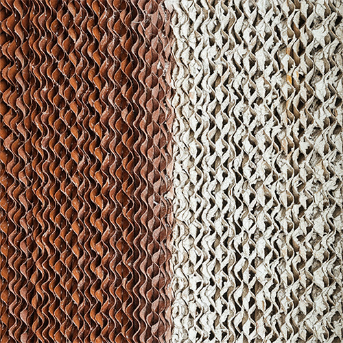 Cooling pad comparison showing heavy mineral scale buildup vs clean wet pad